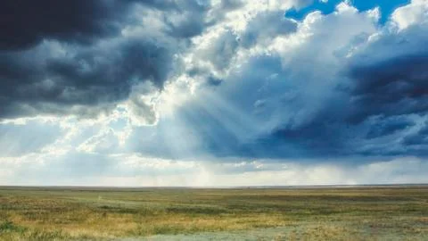 Clouds in the sky before a thunderstorm with sunbeams Stock Photos
