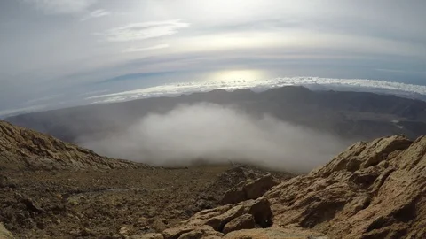 Clouds slide over the tops of the mountains, closeup Stock Footage 105100483
