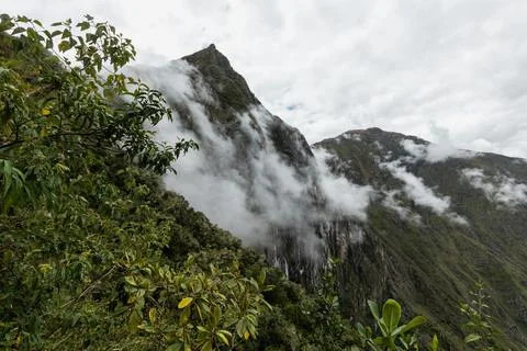 Clouds slip ever down mountains, Machu Picchu, Peru Stock Photos