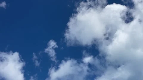 Clouds slowly dissipating in a blue sky Stock Footage 329900570