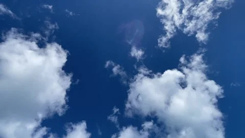 Clouds slowly dissipating in a blue sky Stock Footage 329900735