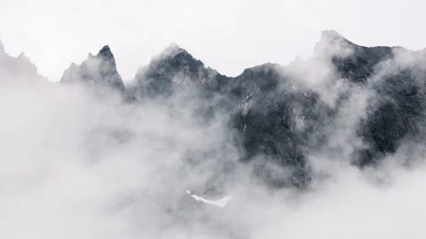Clouds slowly drift around the majestic Troll Wall ridge in Norway Stock Footage 319744971