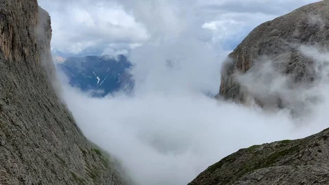 Clouds slowly going up on the mountain peaks Stock Footage 112718539