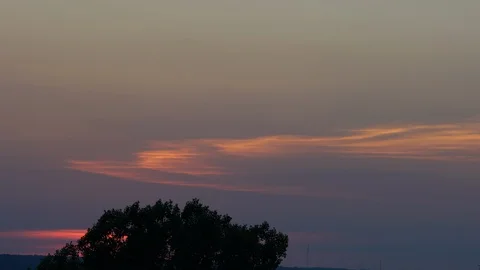 Clouds Slowly Moving across purple sky at sunset Stock Footage 87633507