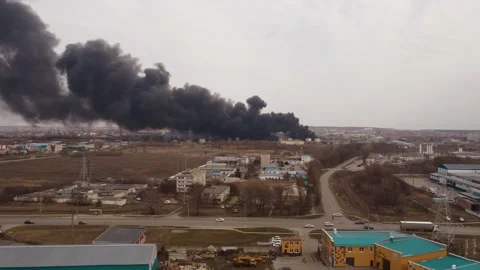 Clouds of smoke and fire in the distance in the industrial zone of the city Stock Footage 258406648