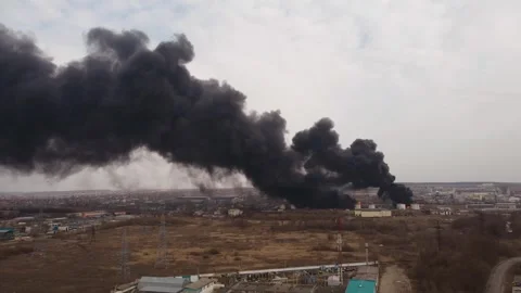 Clouds of smoke and fire in the distance in the industrial zone of the city Stock Footage 258406721