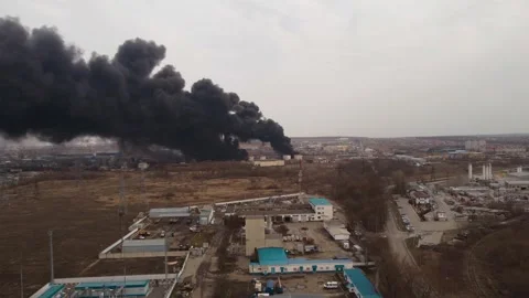 Clouds of smoke and fire in the distance in the industrial zone of the city Stock Footage 258406742