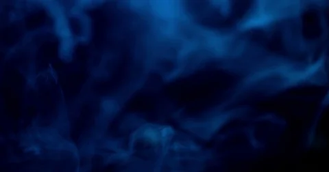 Clouds of smoke on blue background Stock Footage 84523149