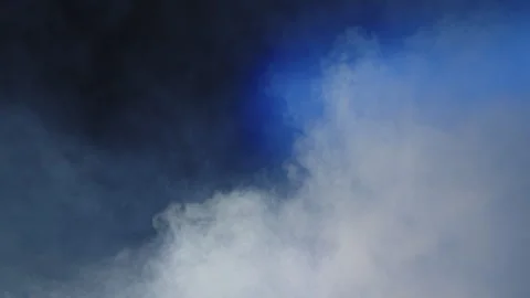 Clouds of smoke moving on a blue background Stock Footage 243765326