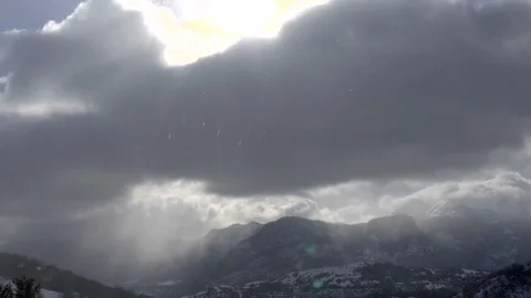 Clouds Snow Rocky Mountains. Low clouds settle along the rocky ridge line. Stock Footage 96377591