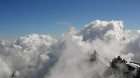 Clouds on Snowy Mountains Stock Footage 57698469