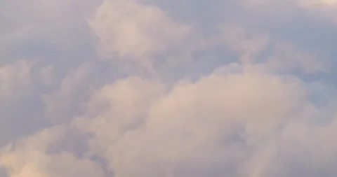 Clouds in soft shades of white and gray float gently across a bright blue sky, Stock Footage 291742689