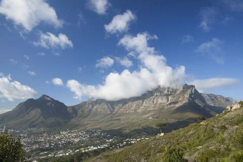 Clouds spilling over Table Mountain in Cape Town. Stock Photos