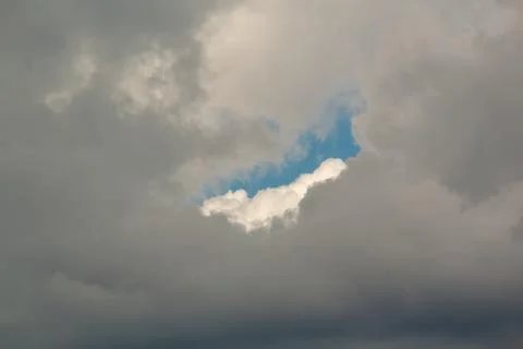 Clouds with a spot of blue sky Stock Photos