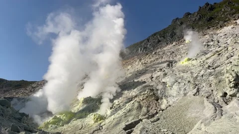 Clouds of steam rising from active volcano fumaroles Stock Footage 228902874