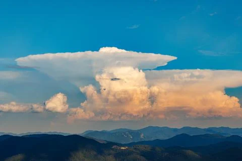 Clouds stretch across the blue sky above the valley of the Rhodope Mountains Stock Photos