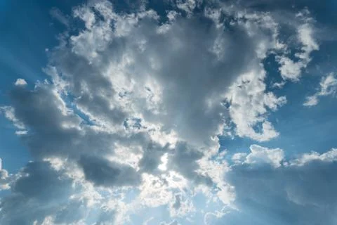 Clouds with sun rays on the blue sky Stock Photos