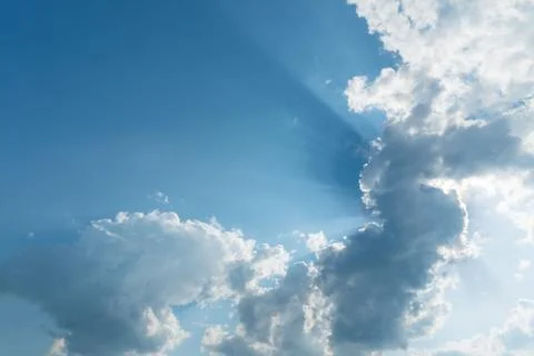 Clouds with sun rays on the blue sky Stock Photos