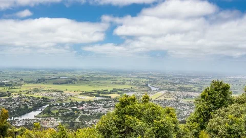Clouds in sunny day over green urban country in New Zealand nature Time lapse Stock Footage 105647399