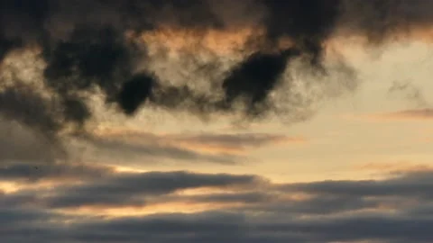 Clouds at sunrise with dark smoke - sky in Real Time - Cloudscape with birds Stock Footage 143213879