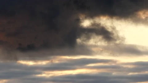 Clouds at sunrise with dark smoke - sky in Real Time - Cloudscape with birds Stock Footage 143216535