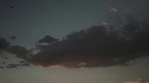 Clouds at Sunset with comet at end Stock Footage