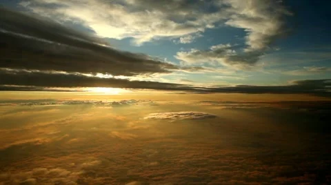 In the clouds by sunset, fading to white when sun breaks through Stock Footage
