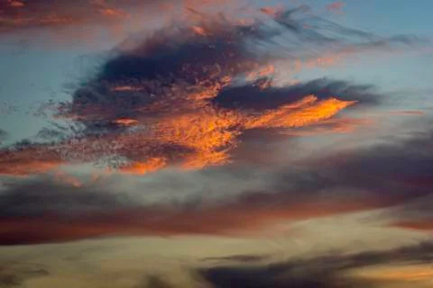 Clouds at sunset with an orange colour Stock Photos