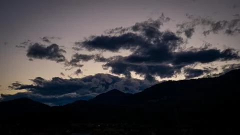 Clouds in the sunset sky over a mountain of Lake Maggiore (Italy) Stock Photos