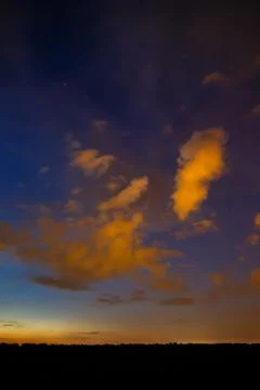 Clouds at sunset in the sky. Stock Photos