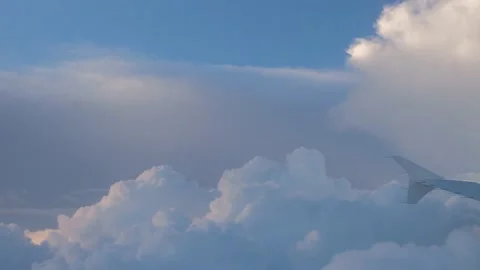 Clouds in the sunset while airplane lifts upwards Stock Footage 140460291