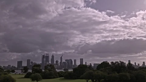 Clouds sweep over Perth City in winter with Swan River in foreground - Timelapse Stock Footage 243497136
