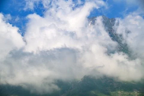 Clouds swirl around mountain summit Stock Photos