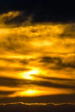Clouds swirl in deep orange Stock Photos