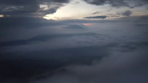 Clouds Swirling Around Distant Volcano at Dawn in Bali Indonesia Vídeos de archivo 342639716