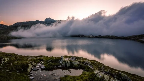 Clouds taking over Totensee in Grimsel, Grimselpass time lapse Stock Footage 119057578