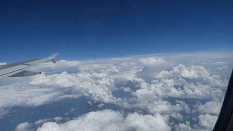 Clouds through airplane window 00063 Stock Footage 90645388