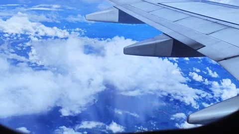 Clouds through an airplane window during flight Stock Footage 255381033