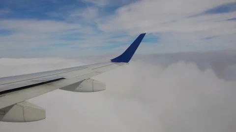 Clouds through window of airplane 스톡 동영상 82872545