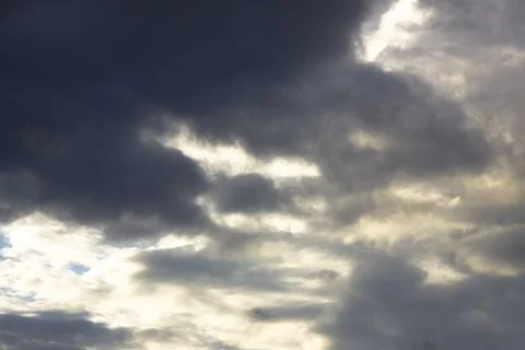 Clouds before a thunder-storm at sunset as a background. Stock Photos
