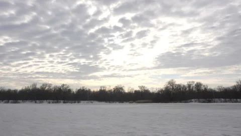 Clouds in time laps in the sky over the snow-covered river Stock Footage 164904826