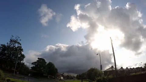 Clouds time lapse imploding above British urban town scene. Fast moving Stockbeeldmateriaal 114385568