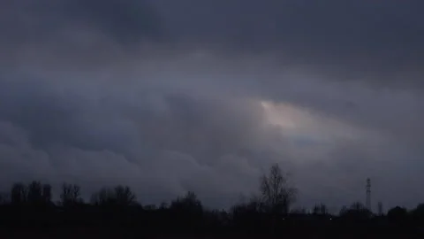 Clouds time lapse moving in blue sky over trees 4K Stock Footage 148456437