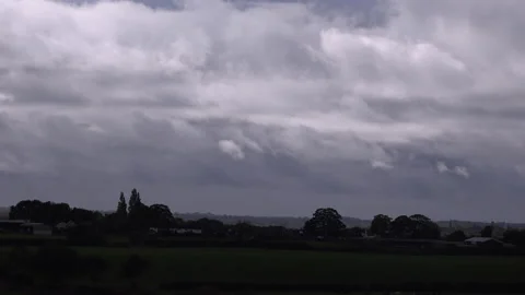 Clouds time lapse over farm field depression lifting 4K Stock Footage 143049714