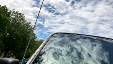 Clouds time lapse reflected on windshield 動画素材 233771335