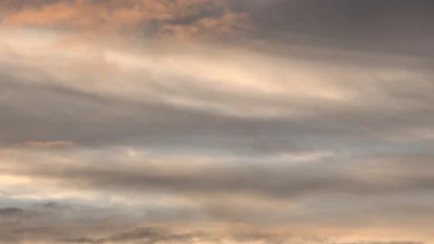 Clouds time lapse sunset golden light moving in blue sky 4K Stock Footage 143559357