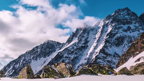 Clouds time lapse winter mountains in alpine snowy nature landscape in sunny day Video stock 170564077