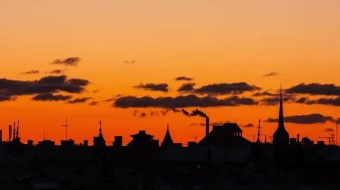 Clouds timelapse at sunset over a city skyline silhouette Stock Footage 48531051