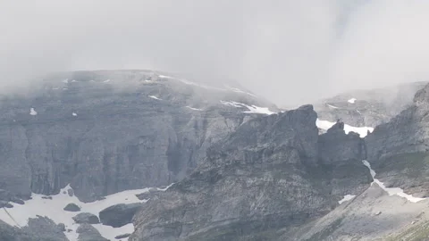 Clouds at the top of a rocky mountain Stock Footage 231468680
