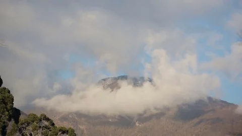Clouds on the tops of mountains. Cloud formation. Time-lapse Stock Footage 73347083